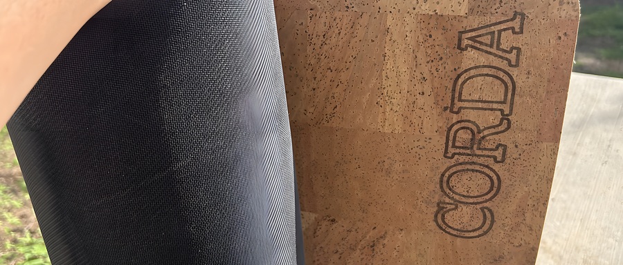 Corda One rolled open showing the cork top and natural rubber base side by side