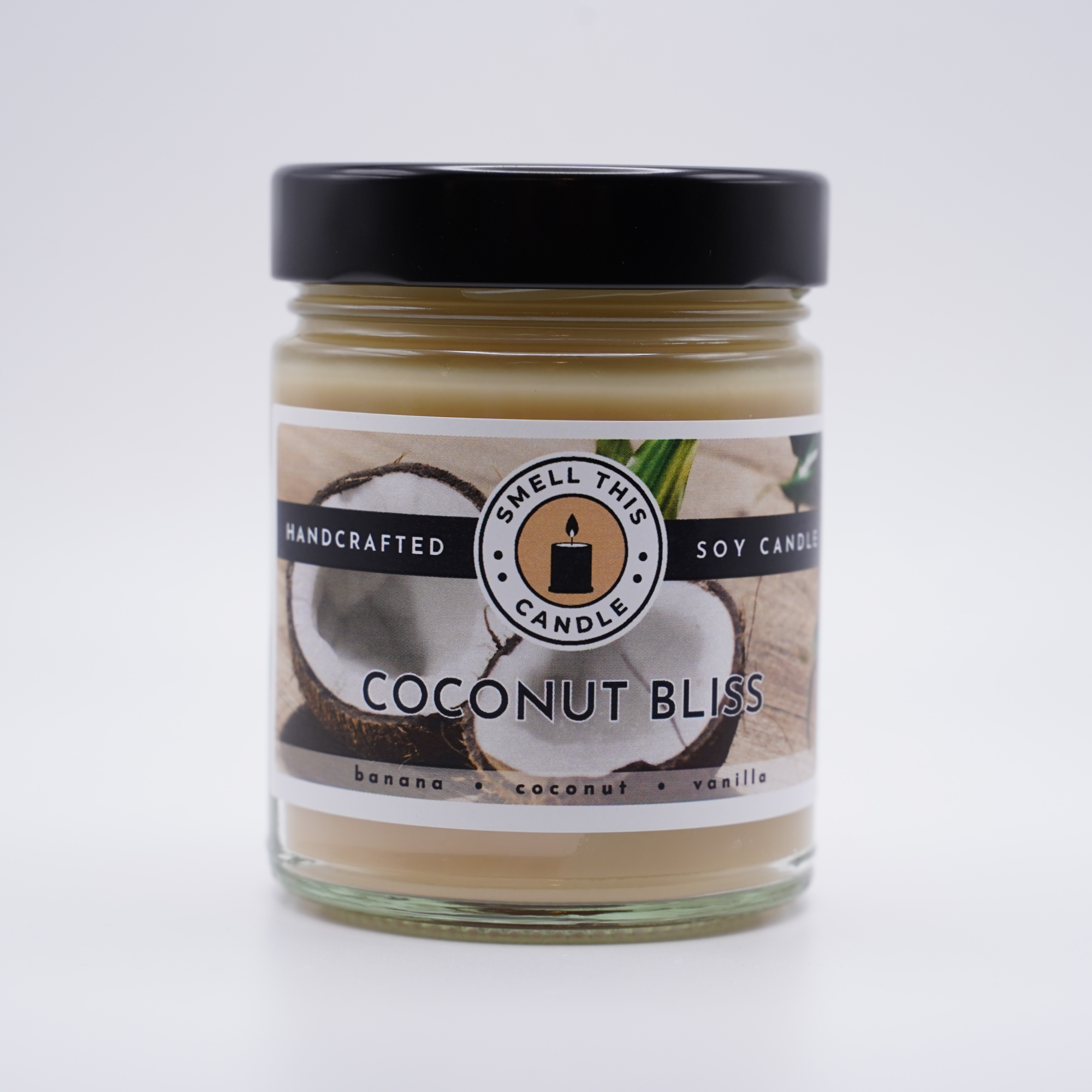 A photo of the Coconut Bliss candle in a simple glass jar with a wooden lid