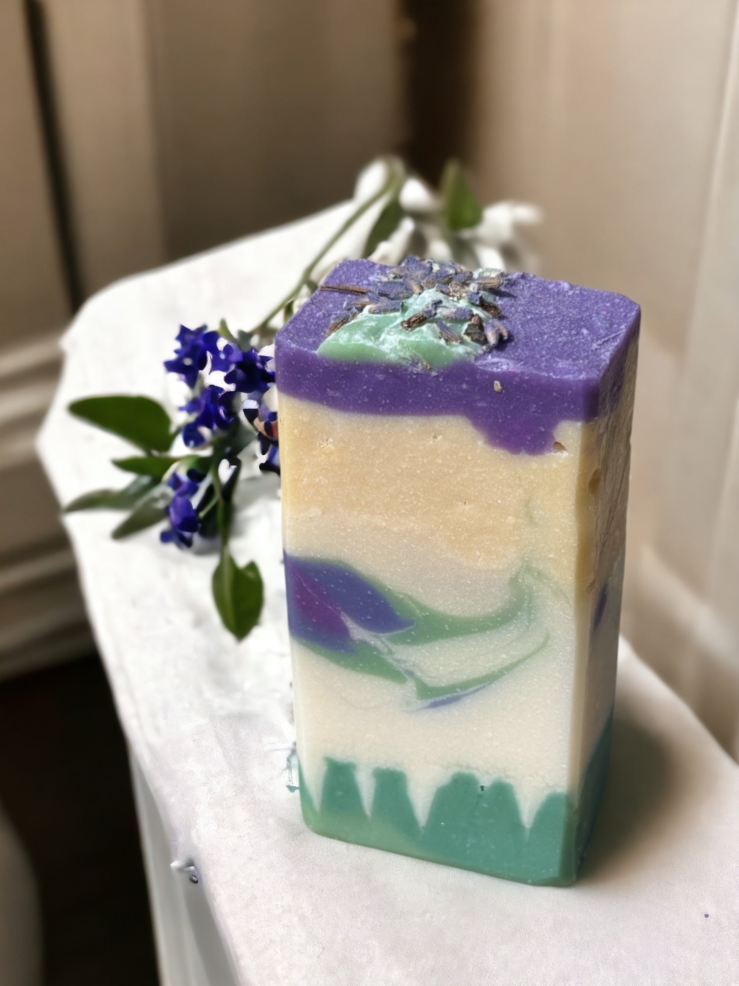 A bar of Texas Bluebonnets Artisan Soap on a wooden surface