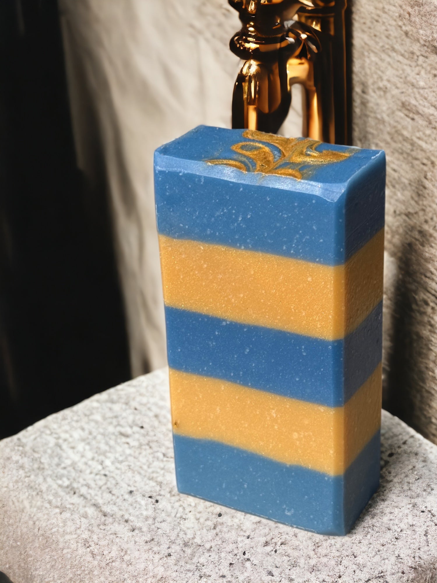 A bar of Noble Oud Artisan Soap on a rustic wooden background