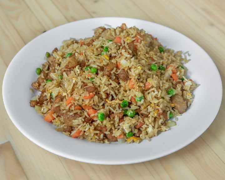 A steaming hot container of Chicken Fried Rice