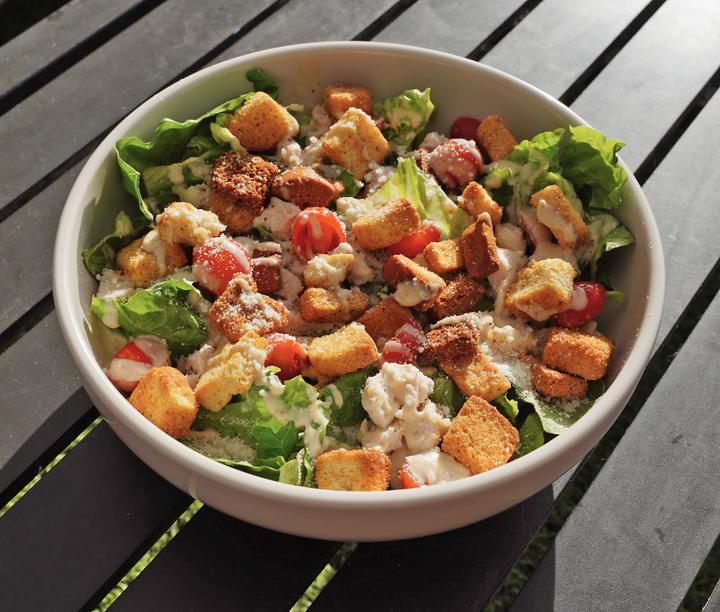 A photo of a Caesar salad in a bowl