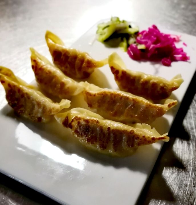 A plate of pan-seared gyoza