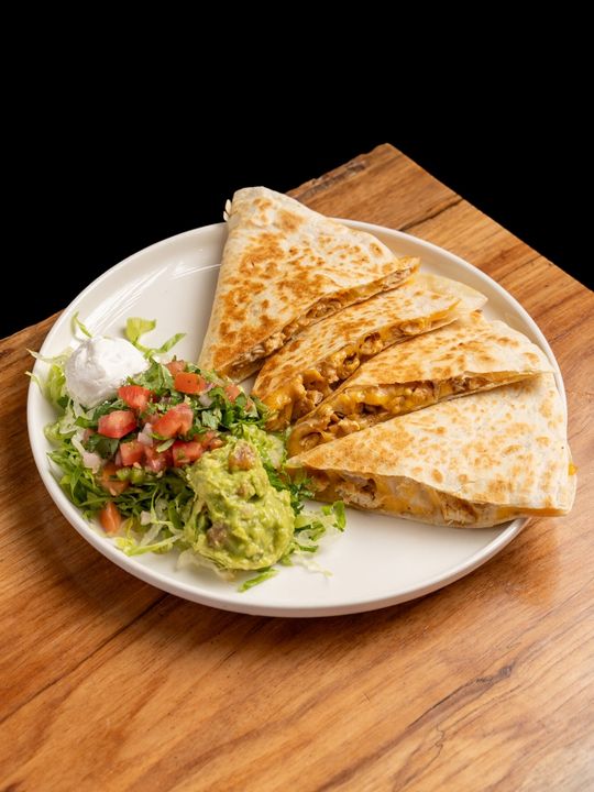 A plate of steaming hot quesadillas