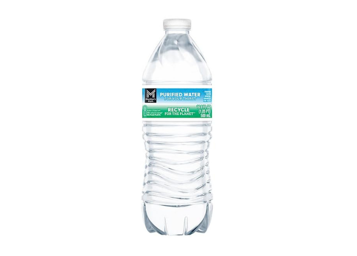 A clear plastic bottle of water on a wooden table