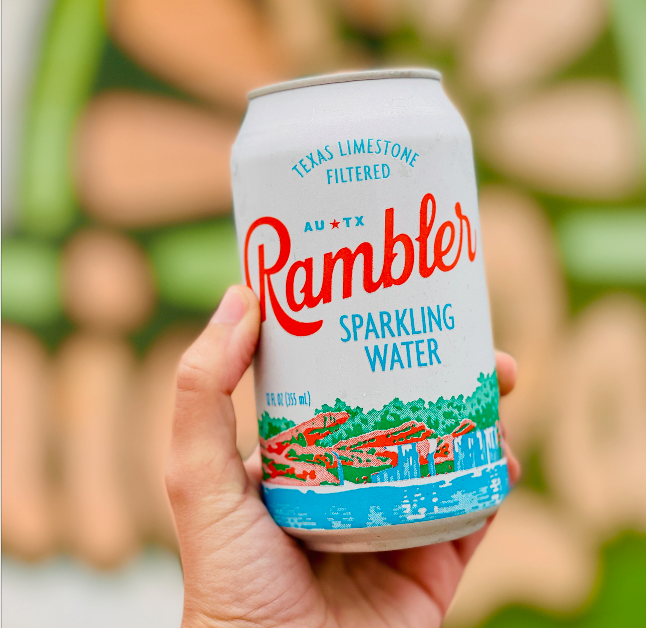 A bottle of Rambler Sparkling Water on a wooden table